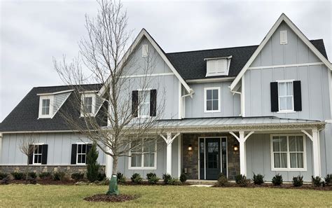 gray house with silver metal roof|gray homes with black roofs.